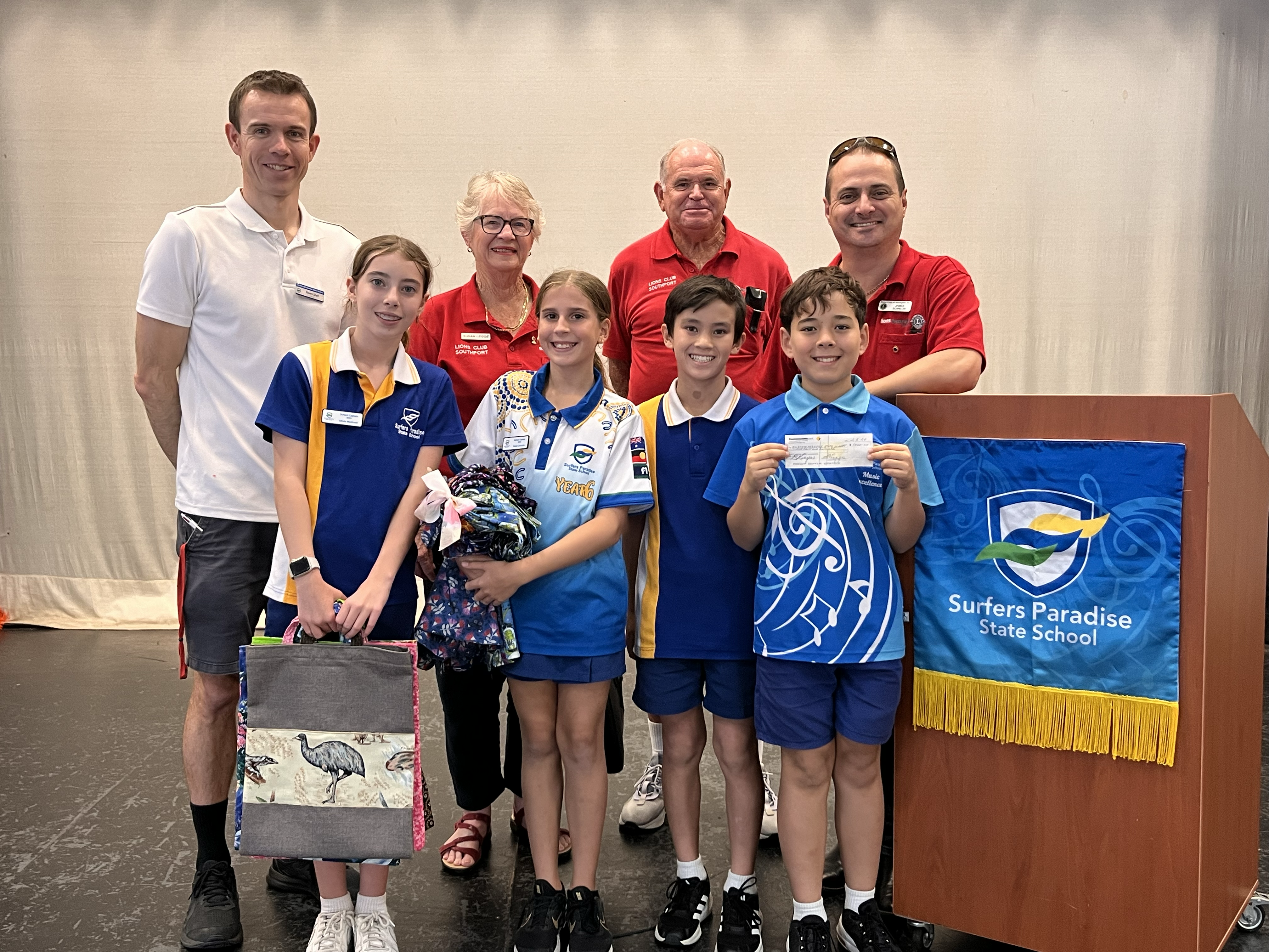 an picture of the cheque presentation ceremony at SPSS with lions members, teachers and students.